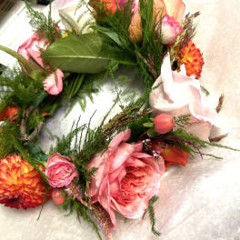 Pink and orange floral wreath with roses and dahlias