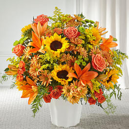 Orange and yellow mixed bouquet in a white vase