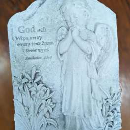 Stone plaque with an angel and engraved memorial text