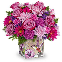 Pink and purple mixed bouquet in a decorated glass vase