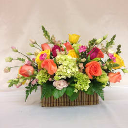 Colorful mixed flower arrangement in a rectangular basket