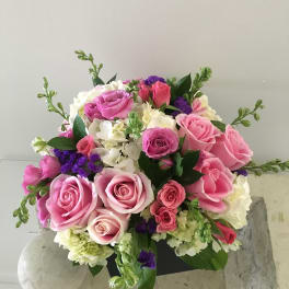 Bouquet of pink and white roses with purple accents
