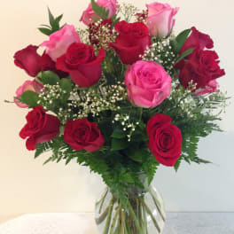 Bouquet of red and pink roses in a clear glass vase