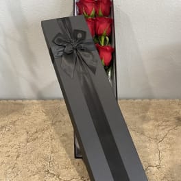 Box of red roses with a black ribbon
