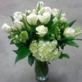 White roses and hydrangea in a glass vase