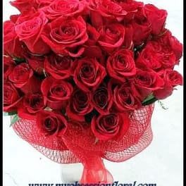Bouquet of red roses wrapped in red mesh ribbon