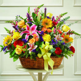 Colorful mixed flower basket with a yellow ribbon