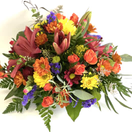 Mixed bouquet of orange, yellow, pink, and purple flowers