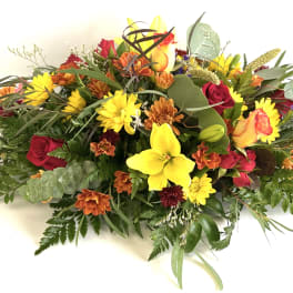 Mixed bouquet with yellow lilies, red roses, and orange daisies