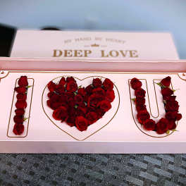 Pink gift box with red roses arranged as "I love U"