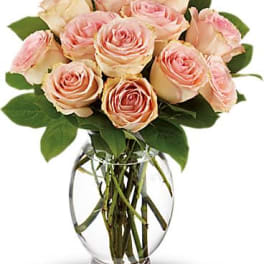 Pink roses arranged in a clear glass vase