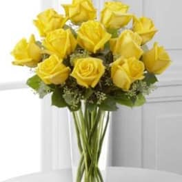 Bouquet of yellow roses in a clear glass vase