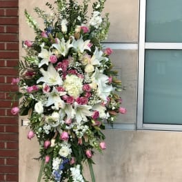 Tall standing floral spray with white lilies and pink roses