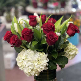 Red roses and white hydrangeas in a glass vase