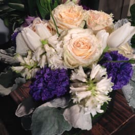 Bouquet of cream roses, white lilies, and purple flowers
