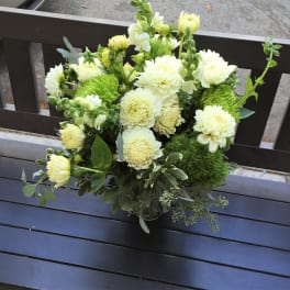 Bouquet of pale yellow and white flowers in a glass vase