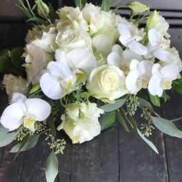 White rose and orchid bouquet with greenery