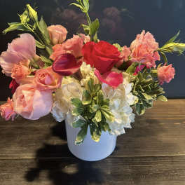 Pink and red mixed bouquet in a white vase