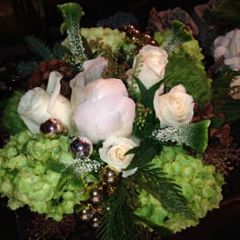 White roses and pale green hydrangeas with metallic ornaments