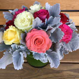 Bouquet of multicolored roses in a green vase