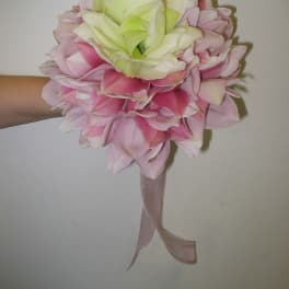Pink and white flower bouquet with a ribbon handle