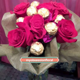 Bouquet of hot pink roses with gold-wrapped chocolates in burlap wrap