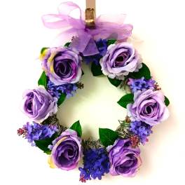 Purple floral wreath with roses and ribbon bow