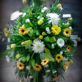 Large standing floral spray with yellow and white daisies