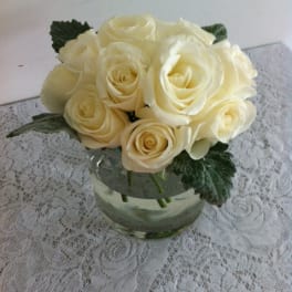 Cream rose bouquet in a clear glass vase