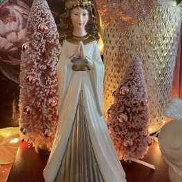 Angel figurine with pink frosted cone trees and a glittery vase