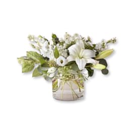 White lily bouquet in a clear glass vase