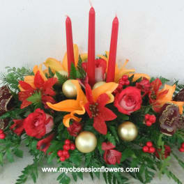 Red and orange floral centerpiece with tall red candles