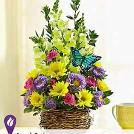 Colorful bouquet in a woven basket with a butterfly decoration