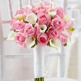 Pink rose and white calla lily bouquet on a chair