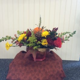 Mixed bouquet in a glass vase with yellow and red flowers