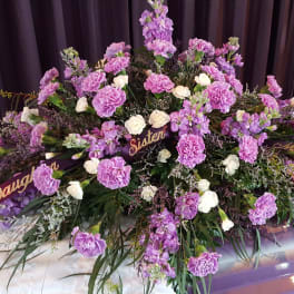Large purple and white funeral spray with ribbon name banners