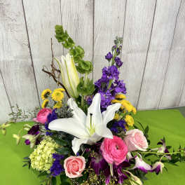 Mixed bouquet with white lilies, pink roses, and purple flowers