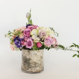 Mixed pink and purple bouquet in a glass vase