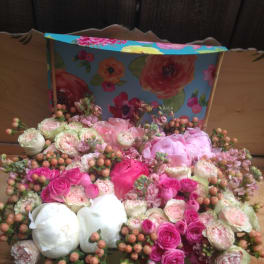 Mixed pink and white flower arrangement in a decorative box