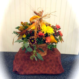 Autumn flower basket with yellow and orange blooms and pumpkins