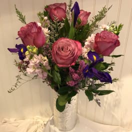 Pink roses and purple irises in a silver vase