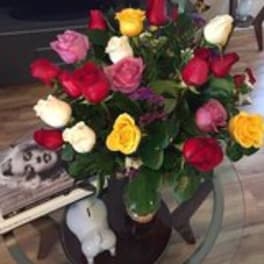 Bouquet of multicolored roses in a glass vase