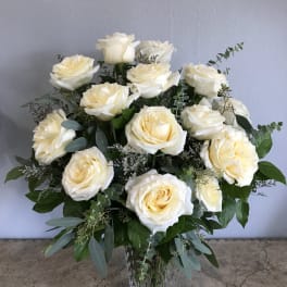 Bouquet of cream white roses in a clear glass vase