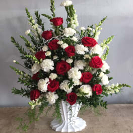 Red roses and white carnations in a white vase