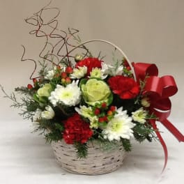 Basket arrangement of red and white flowers with a red ribbon bow