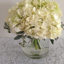 White hydrangea bouquet in a clear glass vase