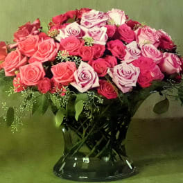 Bouquet of pink and lavender roses in a black vase