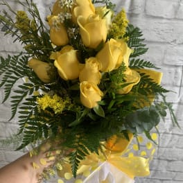 Yellow rose bouquet with greenery and a sheer ribbon wrap