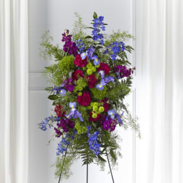 Tall standing floral spray with purple, blue, and green flowers