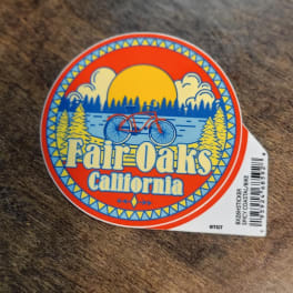 Round Fair Oaks California sticker with a bicycle and sunset graphic